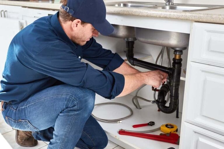 plumber repairing kitchen sink