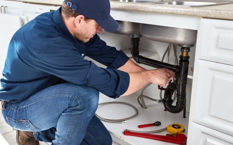 plumber repairing kitchen sink