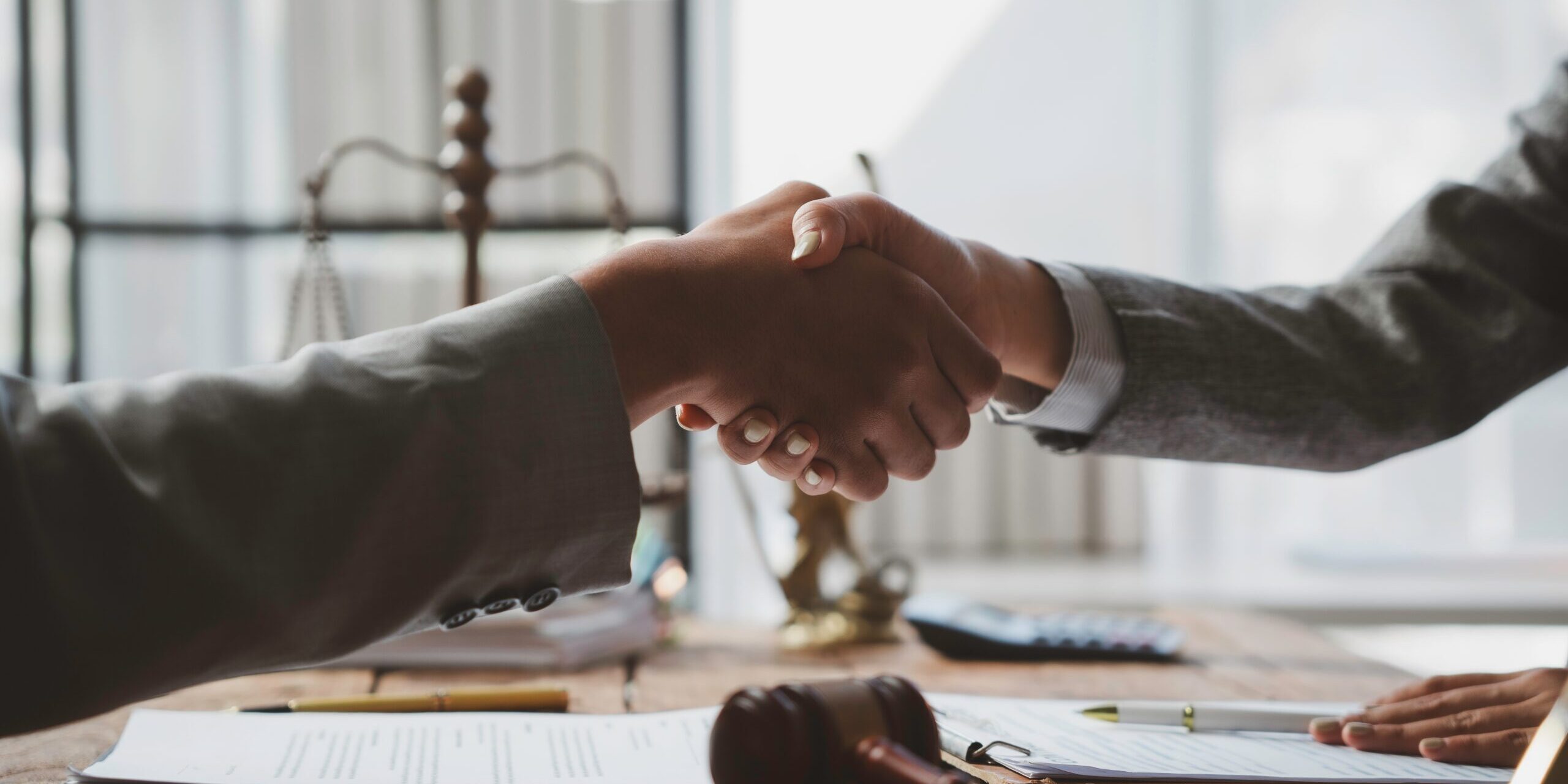 Two,Lawyers,Are,Shaking,Hands,After,Signing,A,Legal,Contract Immigration Lawyer Advertising