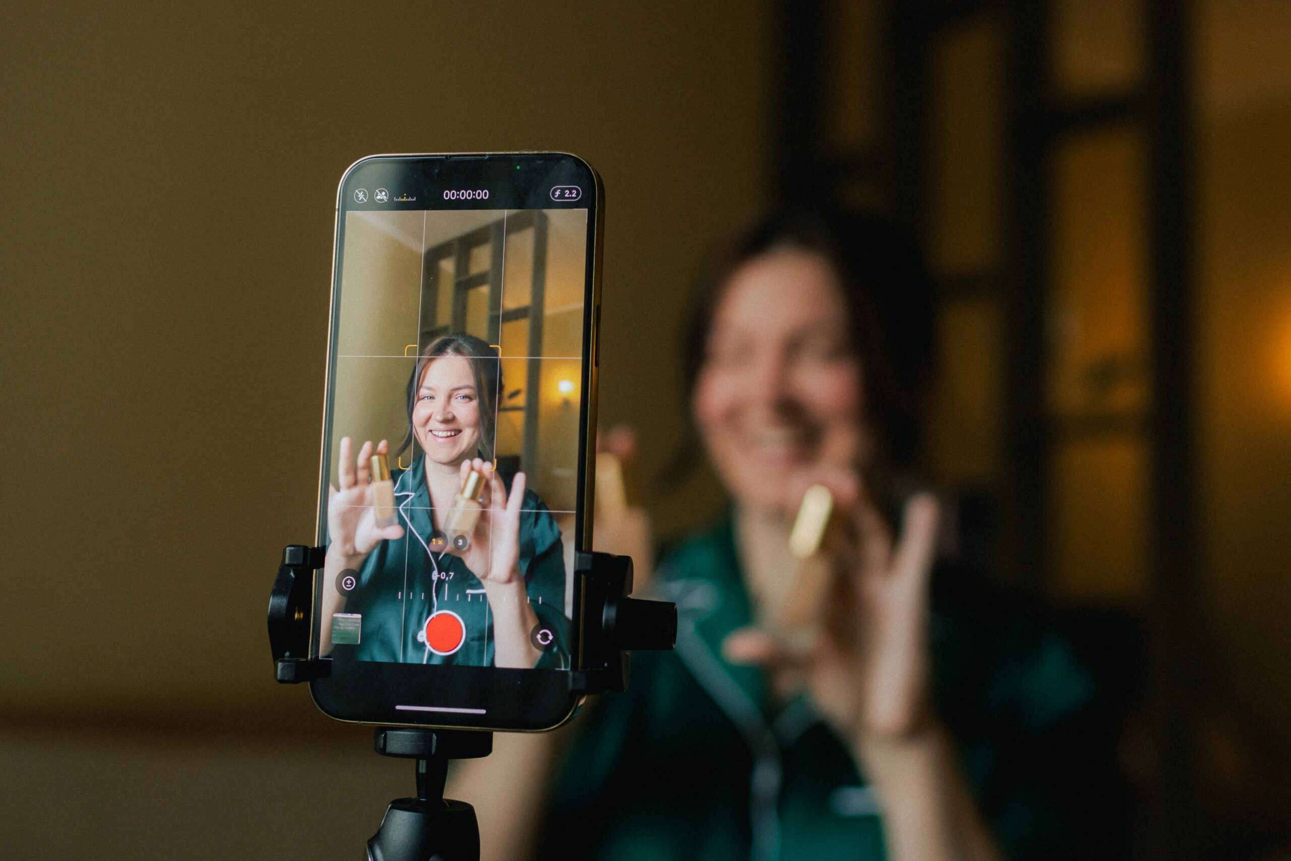 A woman creating User Generated Content for social proof for a makeup brand.