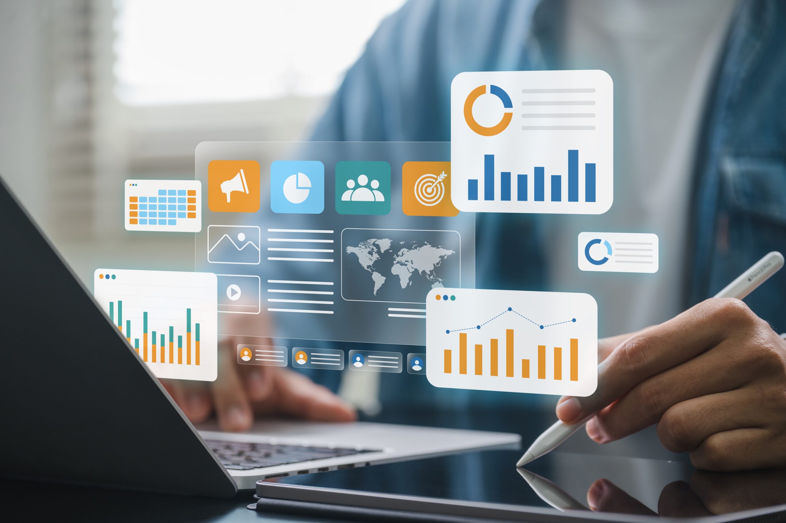 Digital marketing analyst using laptop and tablet to review whether or not the conversion tracking data from campaigns is accurate