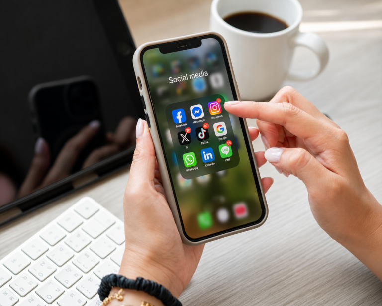 Person using a smartphone with social media apps for eCommerce marketing campaigns