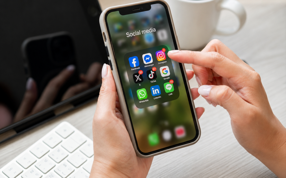 Person using a smartphone with social media apps for eCommerce marketing campaigns