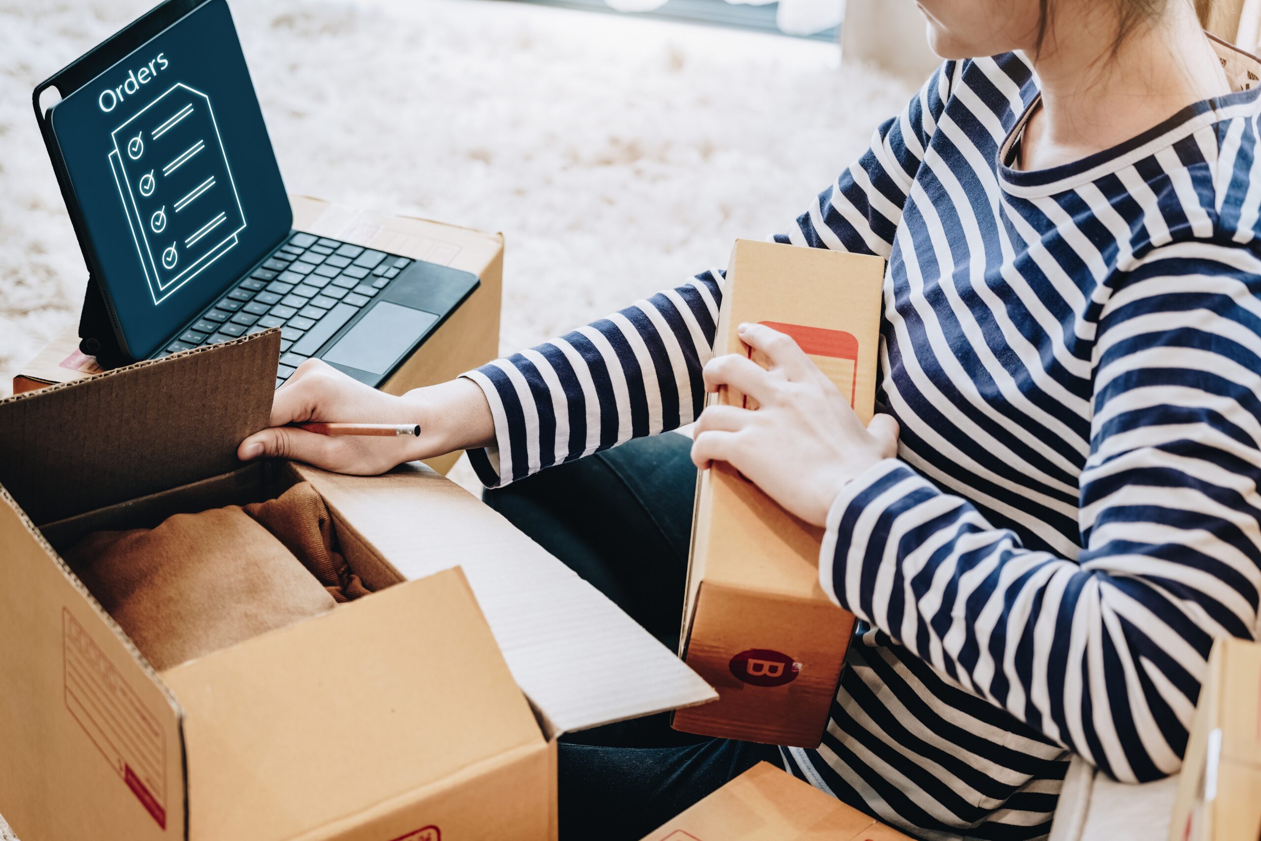 Woman excited to see her Shopify sales through her online store grow.