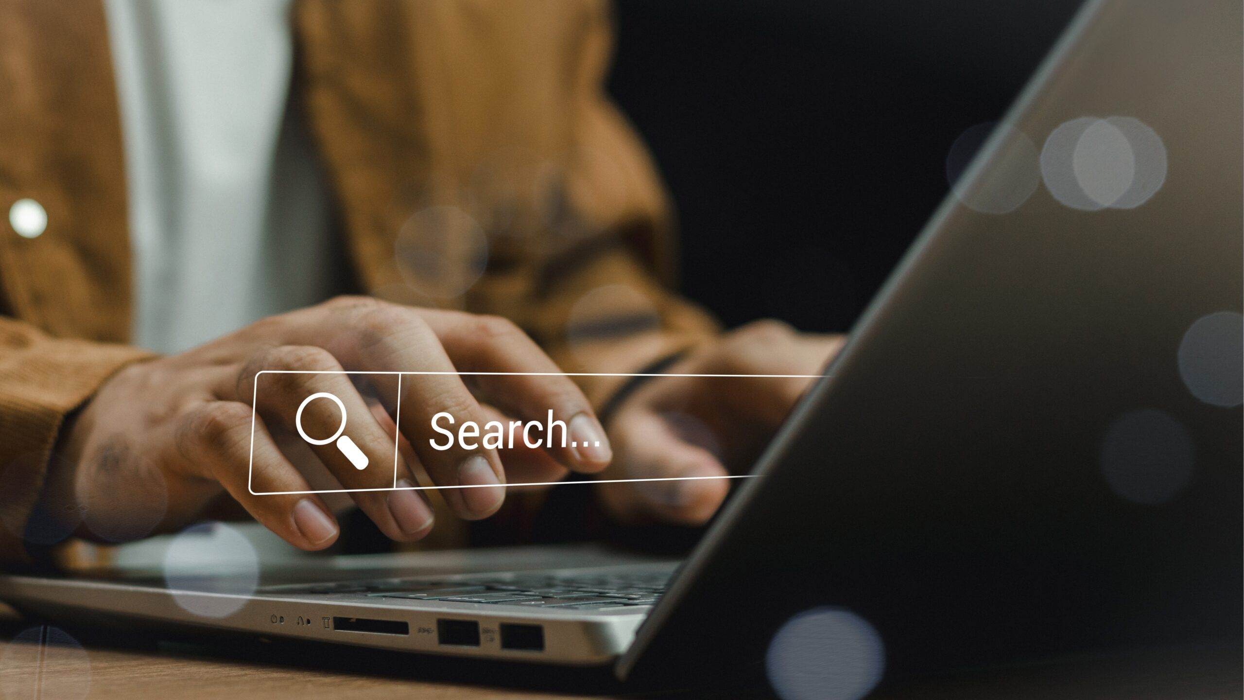 Man with laptop doing Keyword research for e-commerce brand.