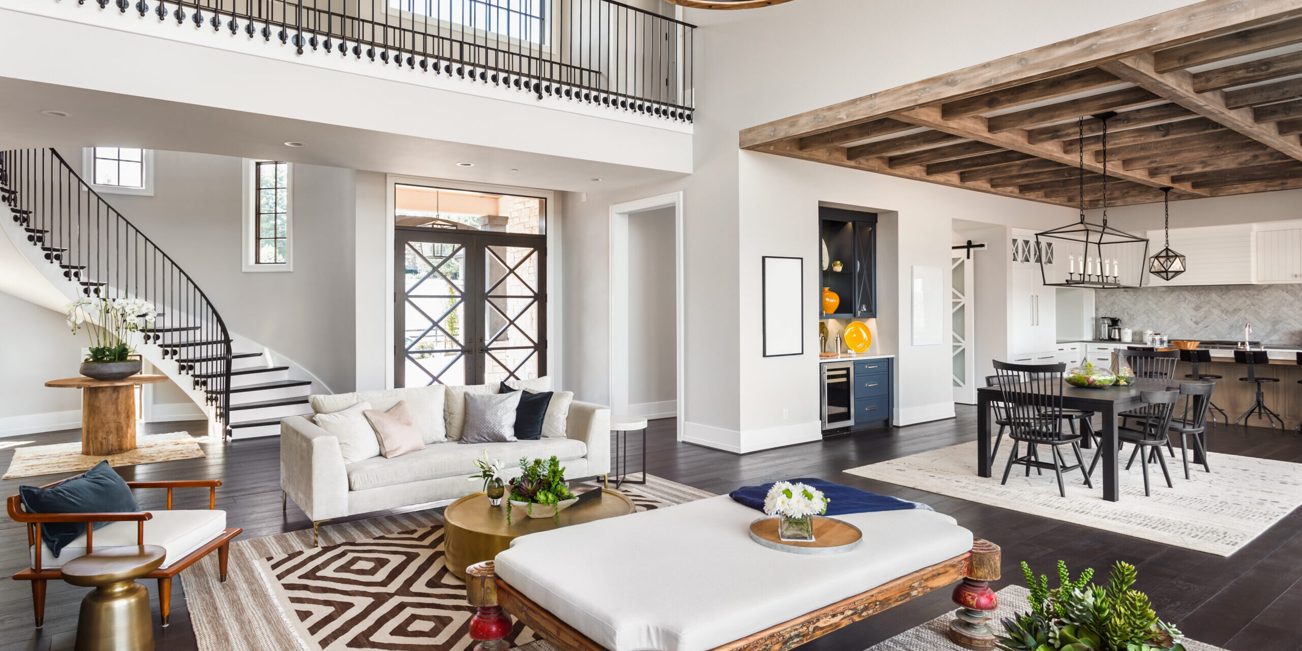 Stunning,Panorama,Of,Luxury,Home,Interior,With,Open,Concept,Floor Stunning Panorama of Luxury Home Interior with Open Concept Floor Plan: Shows Living Room, Dining Room, Kitchen, and Entry. Elegant Stairs Lead up to Second Story. -
