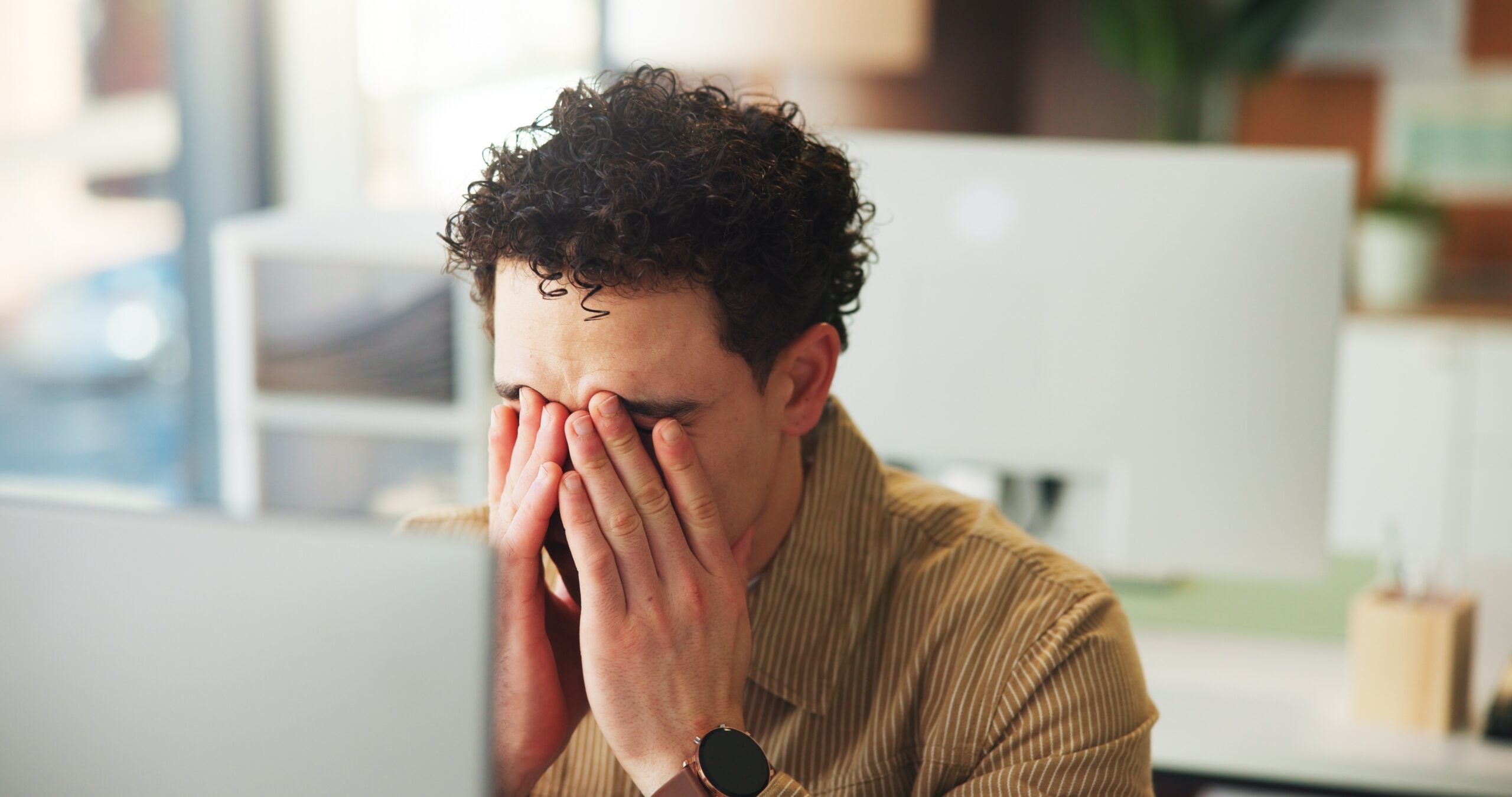 Client unhappy with his marketing agency - Frustrated, man or burnout in office with computer for digital marketing mistake, campaign fail or issue. Upset, person or tech in workplace with creative block, project error or advertising problem.