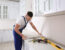A remodeler installing new countertop in modern kitchen
